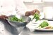Closeup midsection of a chef preparing salad in the kitchen